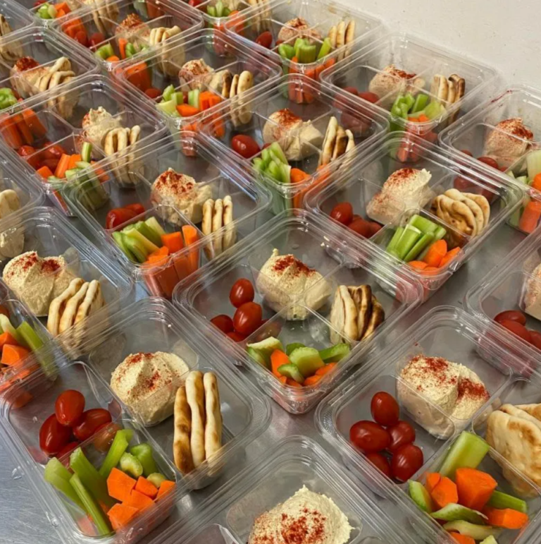 Individually boxed lunches with sandwiches and fresh vegetables for office delivery