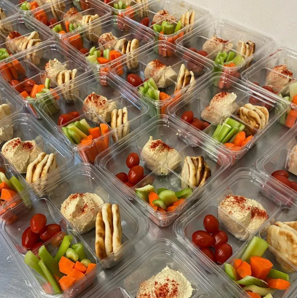 Individually boxed lunches with sandwiches and fresh vegetables for office delivery
