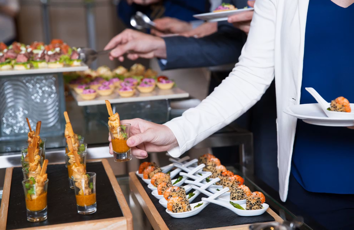 Catering server plating appetizers at a Silicon Valley company holiday party