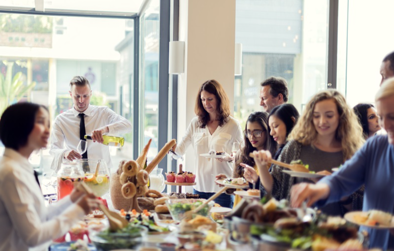 Diverse group of Silicon Valley employees enjoying a catered office lunch