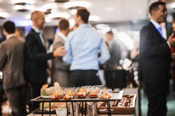 Business professionals networking at a corporate catered event