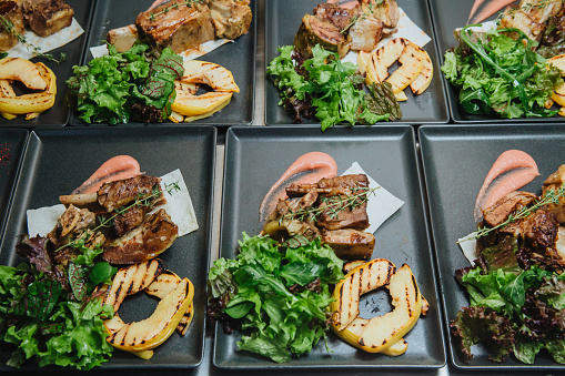 Labeled buffet station showing dietary options at a corporate catering setup